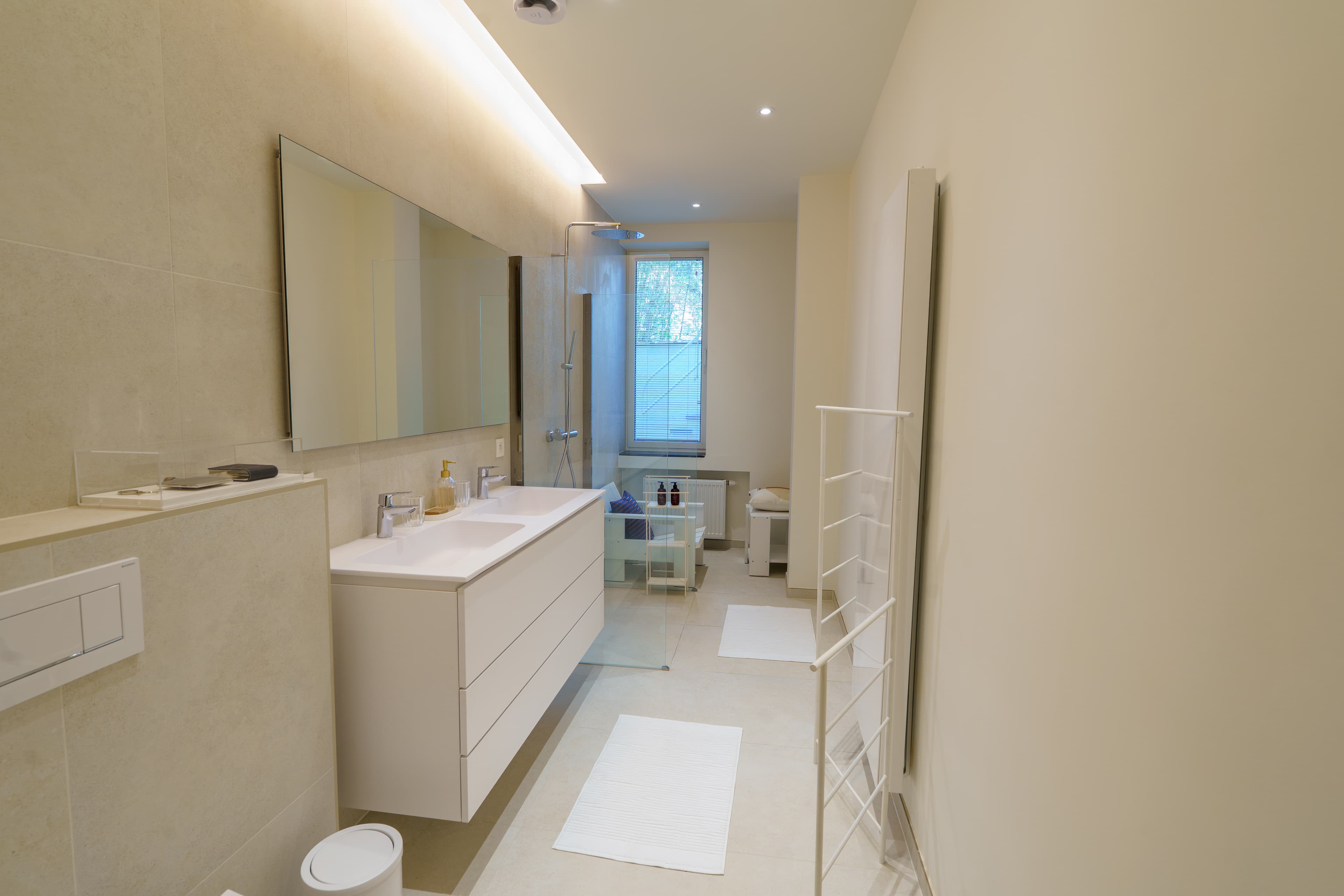 Ground-floor en-suite bathroom with a double vanity and a walk-in rain shower